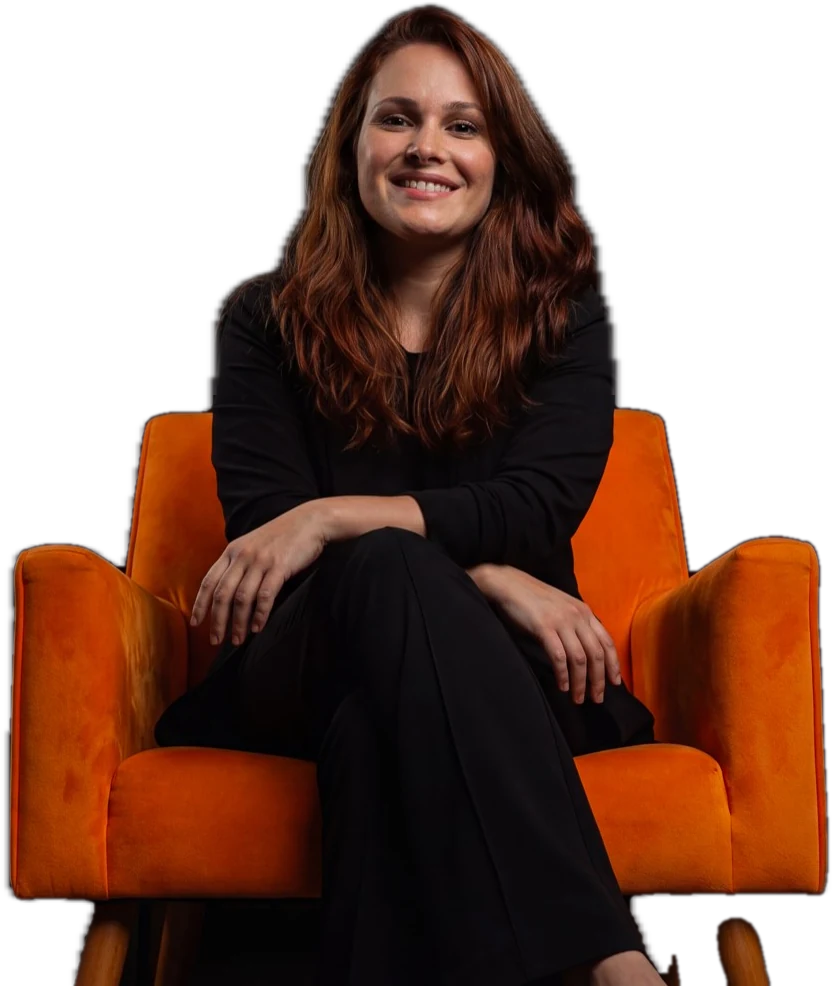 Erika Dorta, founder and film director at Workflow Arts, sitting in an orange armchair