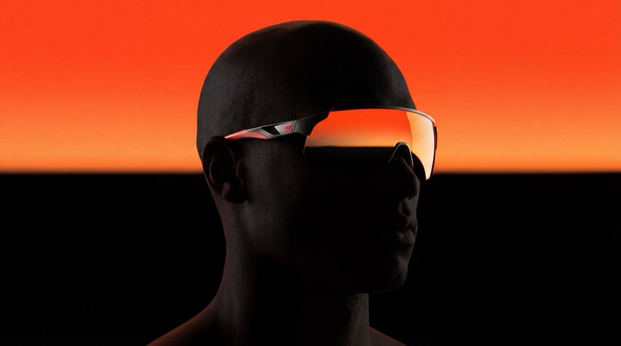 Silhouette wearing orange mirrored glasses